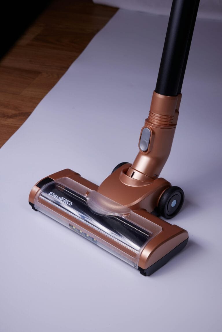 Elegant bronze cordless vacuum cleaner on a white surface, ideal for home cleaning needs.